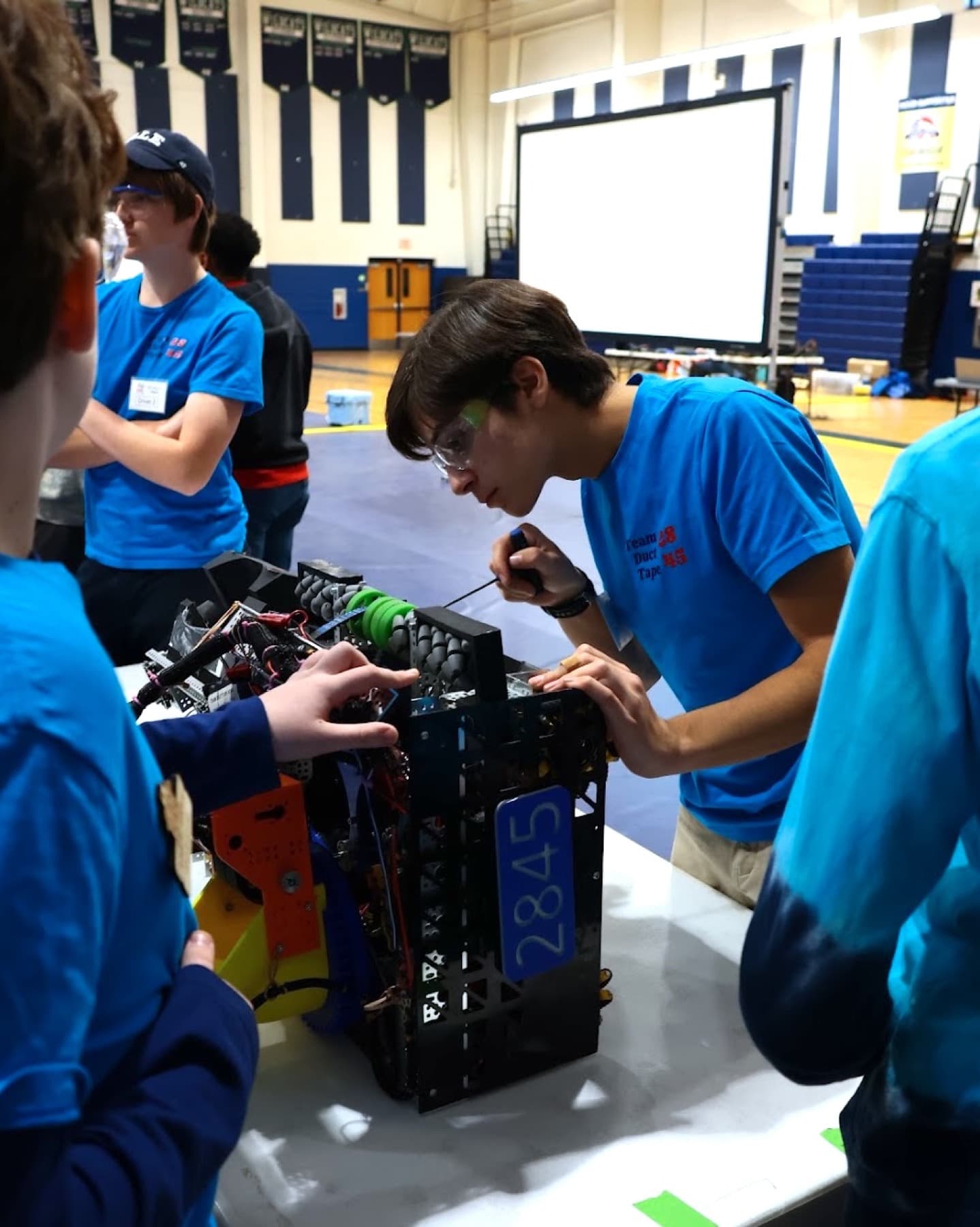 Samuel Anes working on the Team 2845 robot in the pits