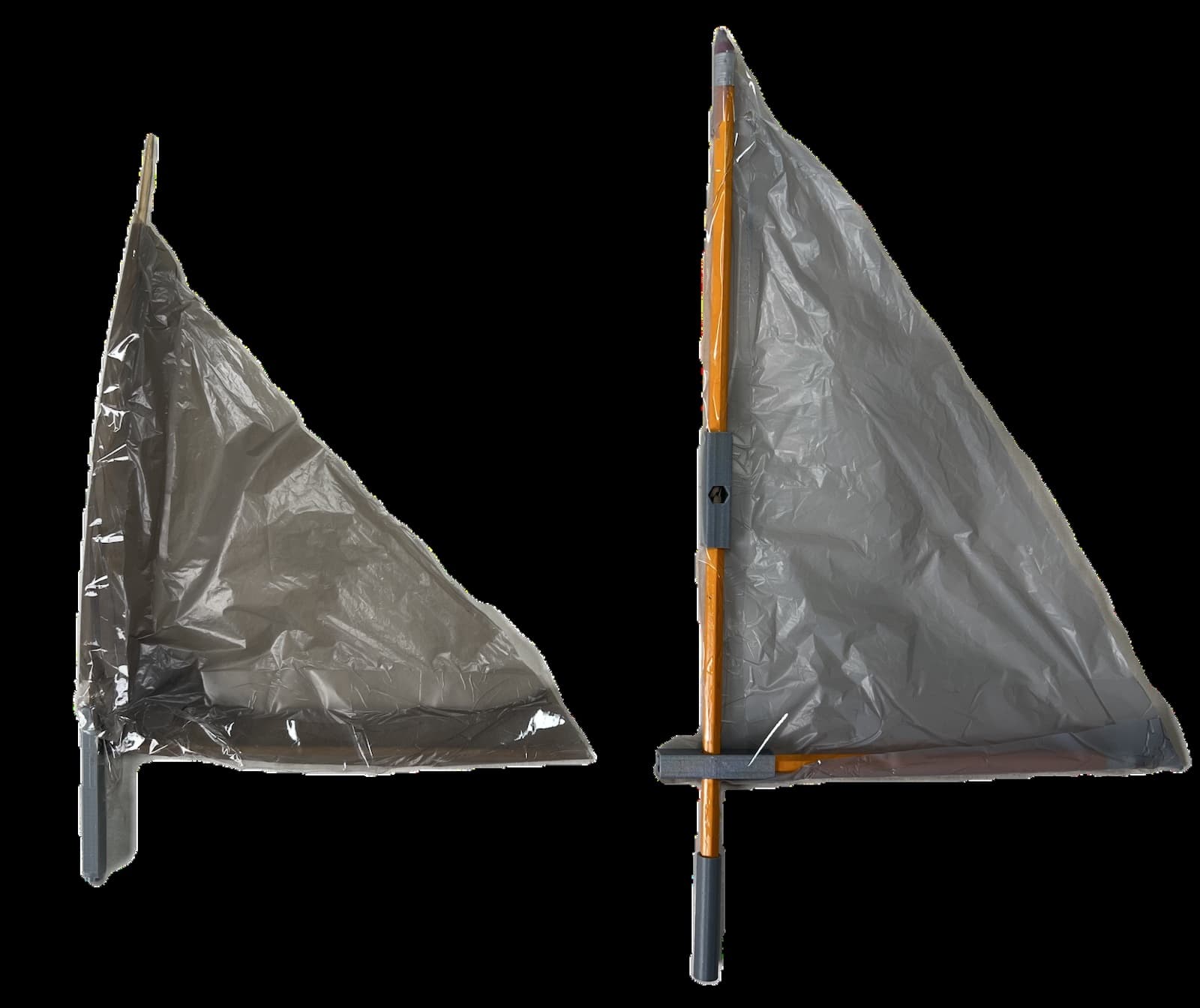 The original kebab-stick sail beside the larger pencil-framed sail